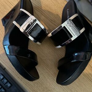 Gently worn Calvin Klein Wedge heel sandal. Shoes have slight scuffs but comfy.